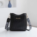 Black crocodile pattern bucket bag with wide lettered strap and gold logo hardware - Black