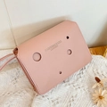 Pink crossbody square bag with circular cut-outs and golden fashion lettering - Pink