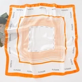 Detail of silk-like square scarf featuring orange border and white flower print pattern - Orange