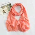 Detail of coral pink mercerized cotton scarf featuring soft fine knit and delicate fringe edge - Coral Pink