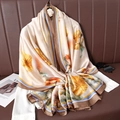 Artistic floral silk scarf in beige and orange, draped over a white shirt for elegant styling - Orange Artistic Flower (Style 1)