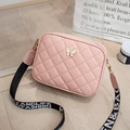 Detail of pink quilted crossbody bag with white butterfly hardware and wide canvas strap - 18*6*13.5cm / Pink