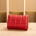 Chic red quilted small square bag with gold chain strap on a wooden surface - Red