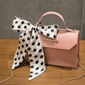 Pink PU leather crossbody bag with a black and white polka dot bow and gold chain strap - Pink