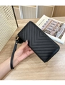 Close-up of black chevron quilted long wallet with golden zipper and faux fur pompom detail - R007 Black