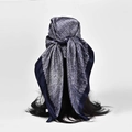 Dark blue satin square scarf with white dots worn as a headscarf on a model - Black