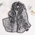 Detail of lightweight black and white floral chiffon scarf with fine white edge piping - 160*50CM / Export Black