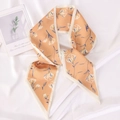 Floral print orange narrow silk scarf styled in a loop on white satin background - Small Floral (Orange)
