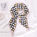 Houndstooth silk scarf with yellow hearts and pink edges displayed on white satin - 9.5x100cm / Style 2 (Checkerboard Heart)