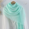 Solid mint green cotton linen scarf with tassels hanging on a wooden hanger - Mint Green