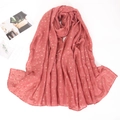 Detailed close-up of brick red cotton linen scarf featuring gold foil clover patterns - Bean Paste (8)