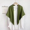 Detailed view of an olive green knit shawl draped over a classic white linen shirt - Autumn Green