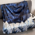 Elegant navy and white feather print silk scarf draped over a grey sofa with accessories - Large Square / Ocean Blue (Blue White Feather Abstract Print)