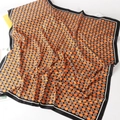 Detail of silk square scarf with orange floral pattern and letter prints on smooth fabric - Dark Brown