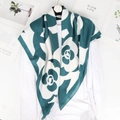 Elegant dark green and white camellia print silk scarf hanging on a black hanger - Large Square Scarf / Camellia Green
