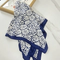 Blue and white camellia silk scarf with elegant floral pattern on white marble surface - Navy Blue