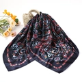 Detail of paisley pattern silk scarf with tassels draped on a woven straw handbag - 90*90cm (Vintage Small Paisley) / Black