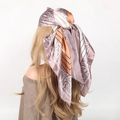 Pink and bronze paisley satin headscarf with geometric patterns on a mannequin head - Spliced Light Orange