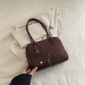 Brown faux suede underarm bag with matching mini pouch on a stylish minimalist background - Coffee