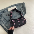 Floral print shoulder bag with black nylon fabric and pink rose patterns with ruffled handle - Black
