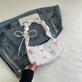 Floral shoulder bag in white fabric with pink rose prints and ruffled handle details - White