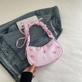 Pink floral shoulder bag with rose pattern and pleated strap in a half-moon design - Pink