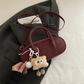 Burgundy faux suede baguette bag with long strap and plush doll pendant on grey suit - Red with Pendant
