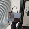 Brown leather and blue fabric patchwork crossbody bag with elegant top handle and tag - Brown