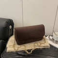 Dark coffee suede shoulder bag with gold chain strap on knit scarf and sofa - Brown