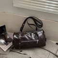 Deep brown cylindrical pillow bag with silver zipper on a checkered suit background - Dark Brown