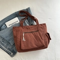 Brown corduroy shoulder tote bag featuring front zipper pocket and side flap compartment - Brown