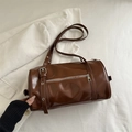 Brown vintage pillow bag in glossy PU leather with silver buckles and zipper details - Tan