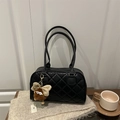 Quilted black tote bag with plush monster charm on casual knit background - Black with Pendant