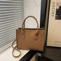 Brown suede tote bag with embossed clover pattern and adjustable crossbody strap - Brown