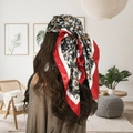 Leopard print satin headscarf with red and white borders shown on a model from behind - K Leopard Wine Red Edge