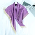 Detail of purple scarf with gold metallic edge trim over white shirt for fashion display - Purple