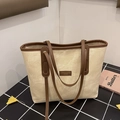 Minimalist beige canvas tote bag with dark brown leather straps and front logo patch - Beige