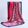 Close-up of a floral satin square scarf with rose pink base and blue floral patterns - 90*90cm / Rose Red