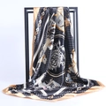 Detail of silk-satin square scarf featuring black and gold horse carriage patterns - Black and Gold Chariot Style