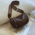 Deep brown Boston pillow bag with wide herringbone strap and golden hardware accents - Brown