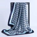 Detailed view of floral satin square scarf draped on a rack showing silky texture - Refresh Blue / 90x90cm