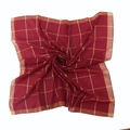 Detailed close-up of red plaid cotton scarf with golden metallic thread grid pattern - Burgundy