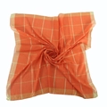 Detail of orange cotton square scarf featuring gold thread plaid pattern and rolled edges - Orange
