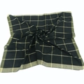 Macro detail of black and gold checkered scarf fabric showing soft spiral draping texture - Black