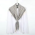 Detail of beige geometric chevron scarf showing natural crinkle texture on white background - Off-white
