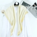 Light yellow linen scarf with gold silk border displayed on white top and accessories - Beige