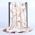 Detailed view of the silk satin square scarf with gold chain print and striped edges - Beige