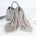 Elegant 70cm satin square scarf with geometric rings draped over a luxury leather handbag - Gray
