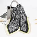 70cm black paisley print silk square scarf with green border draped on a handbag - Black+Yellow