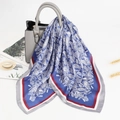 Royal blue paisley silk scarf with burgundy border draped over a grey leather handbag - Blue